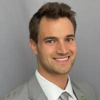 Headshot of Kyle Kane, a Health Informatics and Bioinformatics (HIB) student at GVSU, smiling at the camera in front of a plain gray background.